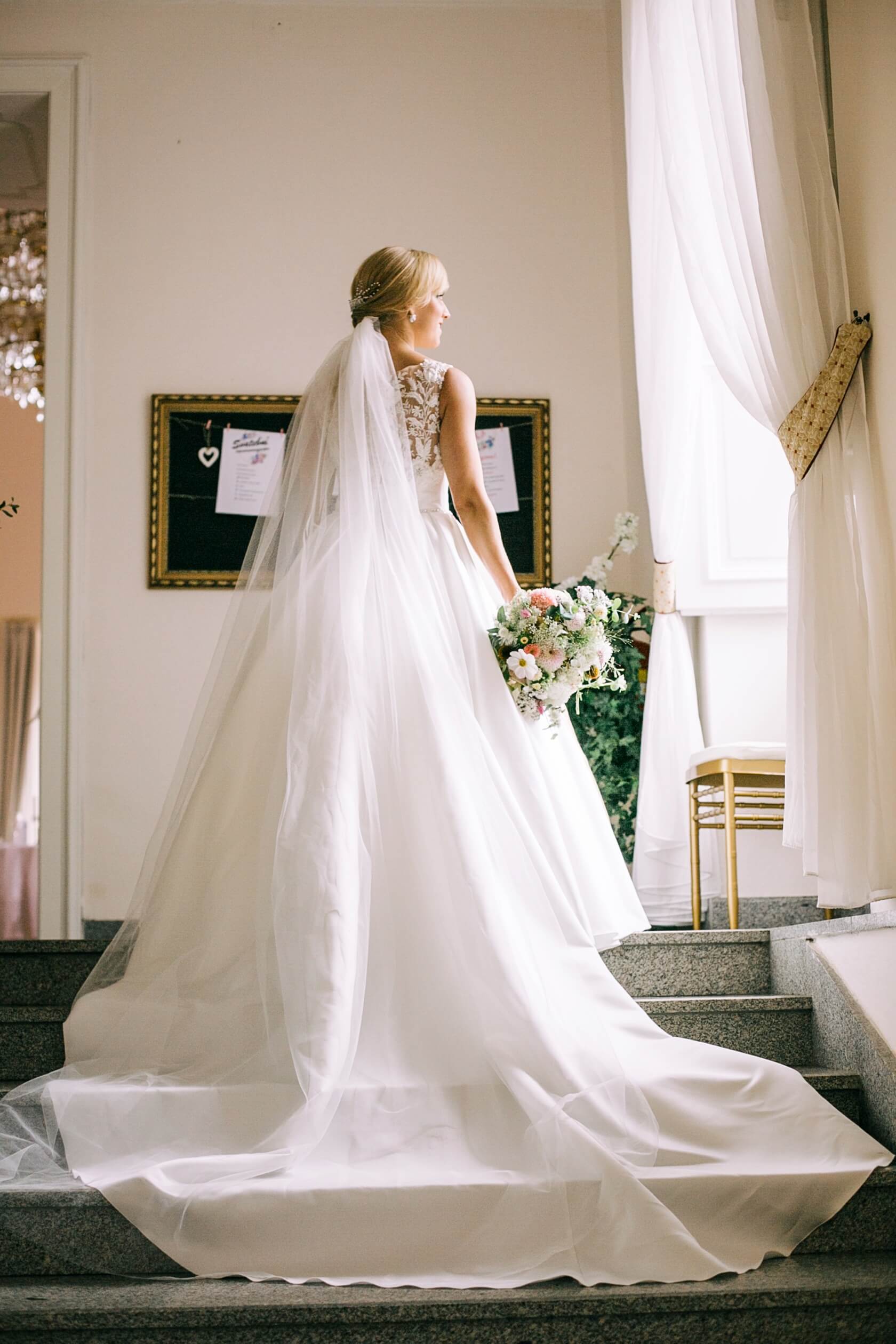 bride-looking-out-of-window-castle-bechyne