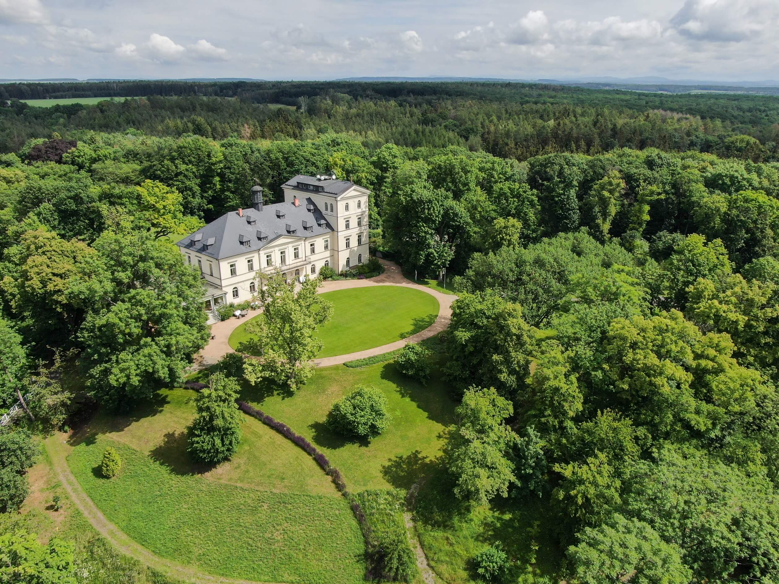chateau mcely drone shot with vast forrest