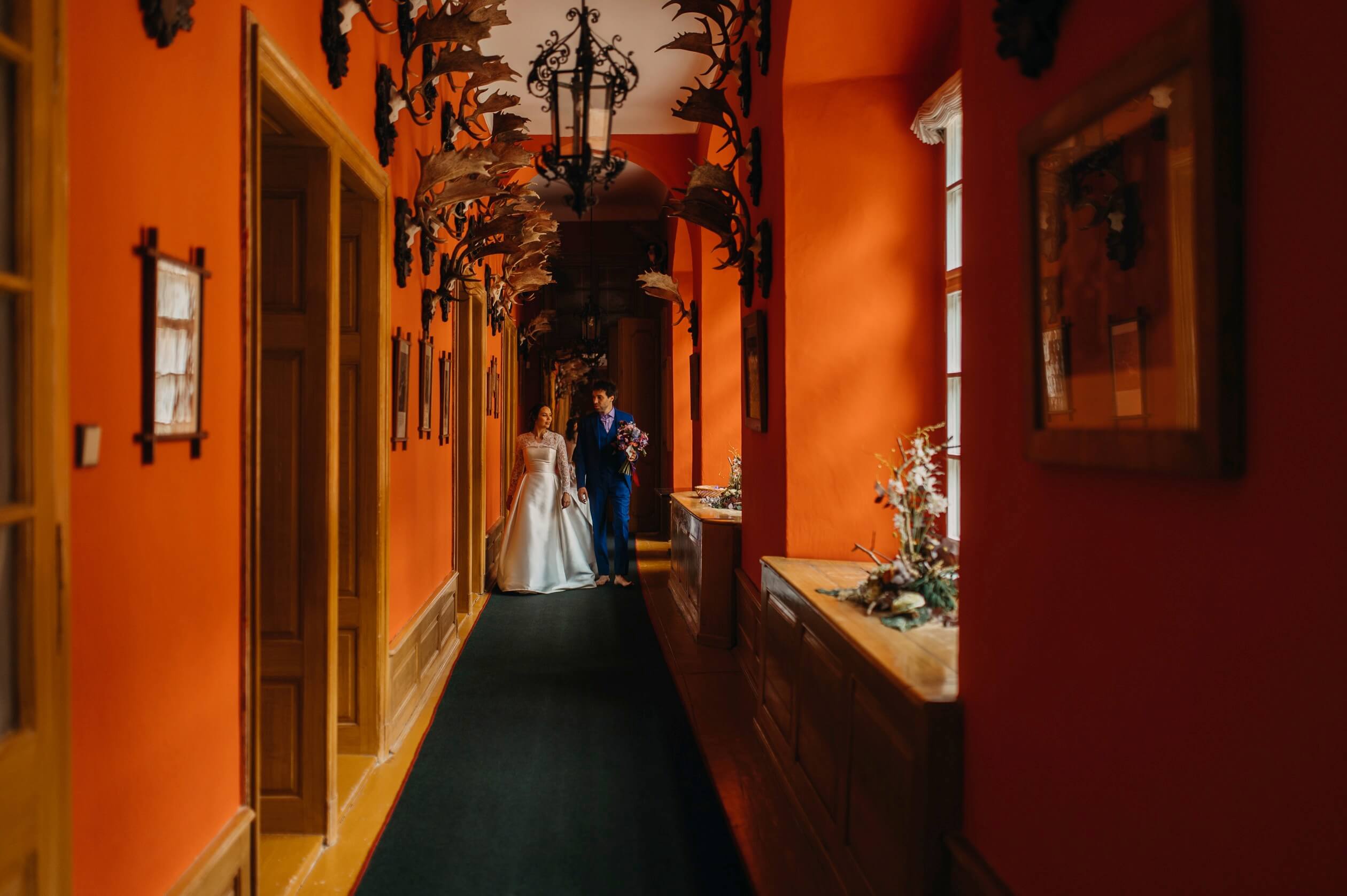 newlyweds walking in hallway castle bechyne